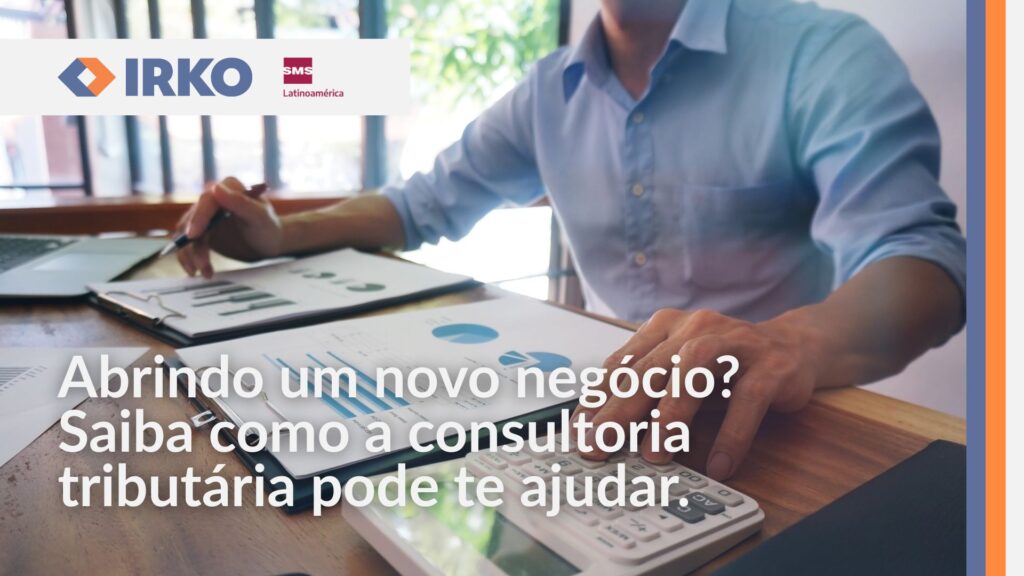 Empresário analisando relatórios financeiros com gráficos e calculadora sobre a mesa, representando o planejamento tributário para novos negócios.